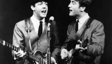 Paul McCartney, left, and John Lennon during a November 1963 Beatles show in London. The next month, the band had its first big hit in the U.S. and Beatlemania started to sweep America.