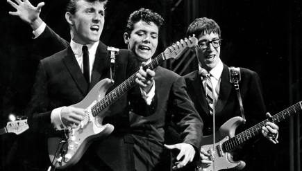 The Shadows on stage in the 1960s. The British rock act, formed as a backing band for singer Cliff Richard (center), was among the UK acts who stayed behind as The Beatles and others were cresting in America.