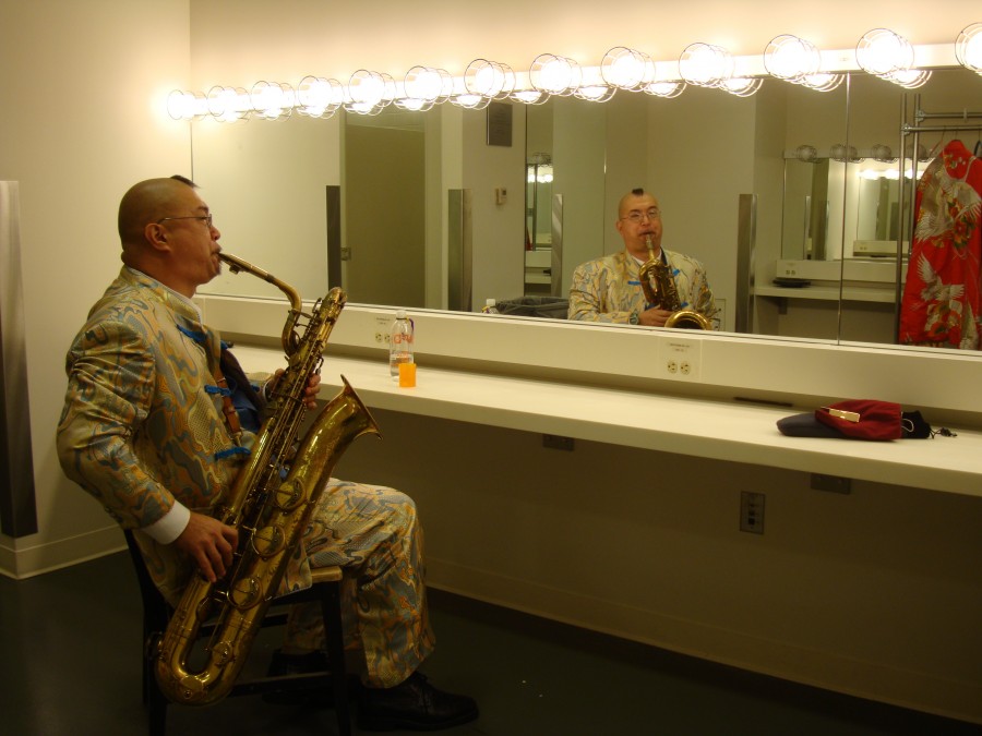 Fred Ho practices his baritone in a dressing room before a performance.