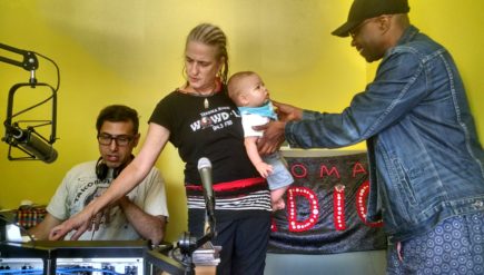 All ages show: Takoma Radio founder Marika Partridge holds the baby of a community member at an "open studio" earlier this year.